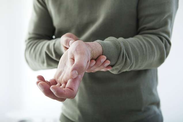 A man holding his wrist in pain